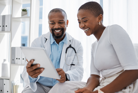 Doctor and Woman smiling looking at medical charts