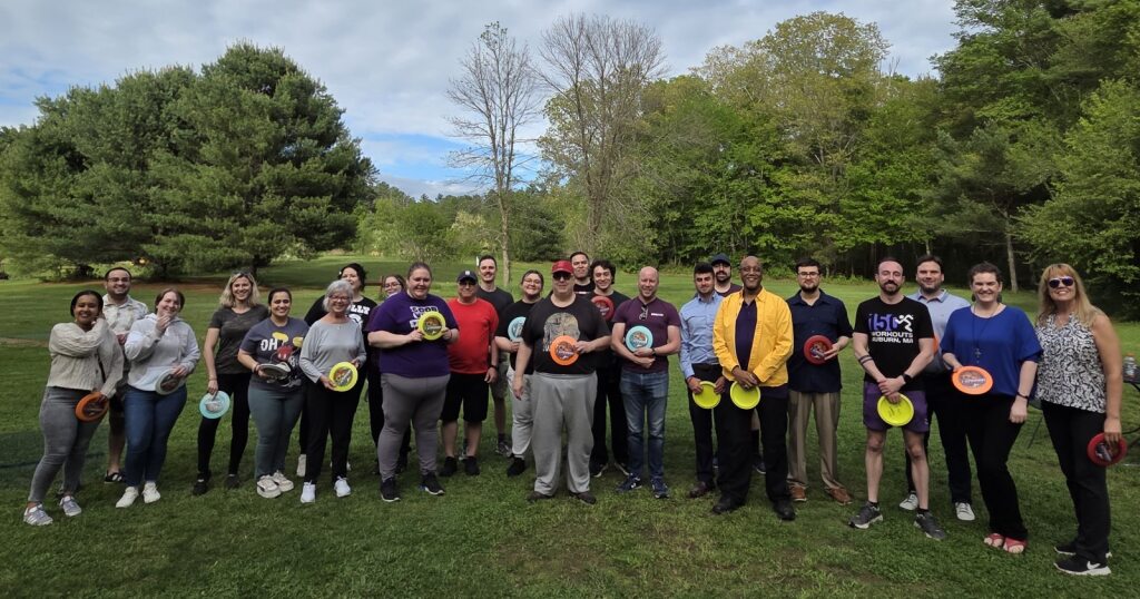 UniBank Employees taking a group photo while playing disc golf