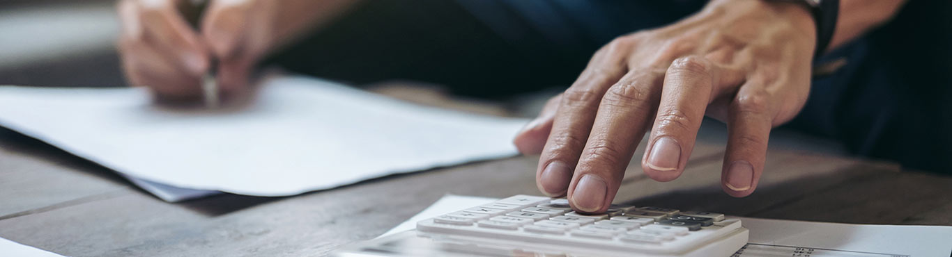 Hands working on a calculator